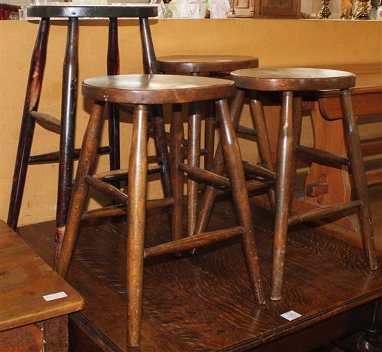 Three stools and one other taller